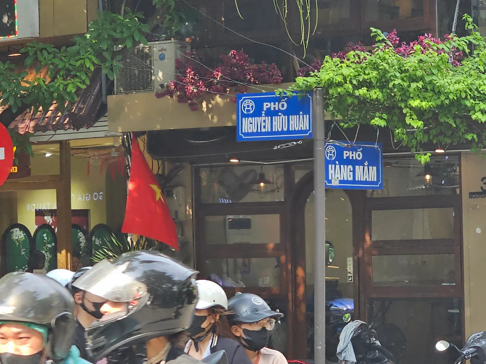 Motoristas circulando con casco por una avenida de Vietnam