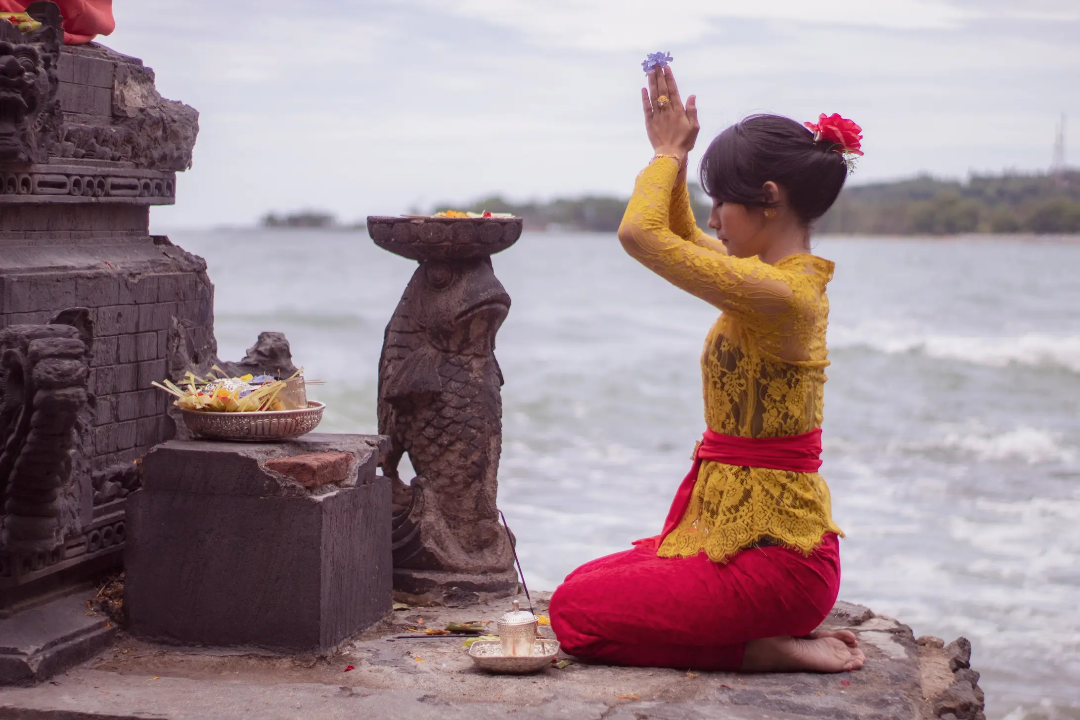 Mujer balinesa con una ofrenda de flores en las manos, Bali